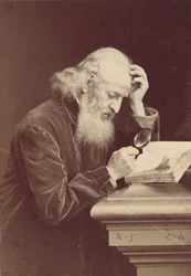 [Homme barbu avec une loupe examinant un manuscrit], 1870s