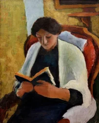 Femme lisant dans un fauteuil rouge