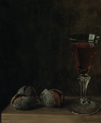 Un verre de vin avec des noix sur une table