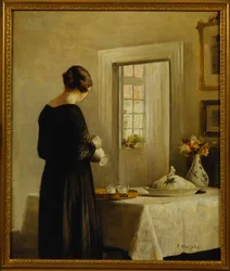 Un intérieur avec une femme à une table