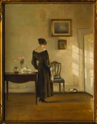 Un Intérieur avec une Femme nourrissant un Chat