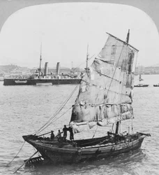 Jonque chinoise et cuirassé britannique dans le port de Hong Kong, 1902