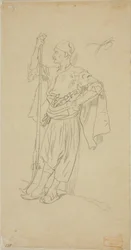 Arabe armé appuyé contre un mur