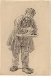 Homme appuyé sur un comptoir