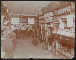 Laboratoire de films Empire Film Co. (possiblement à Broadway et 55e Rue) avec des hommes travaillant et des bobines de film et des caméras