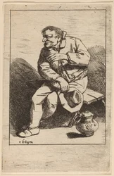 Homme assis avec son chapeau dans la main droite