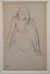 Femme assise au bord de l
