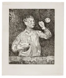 Garçon soufflant des bulles de savon