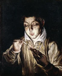 Un garçon allumant une bougie
