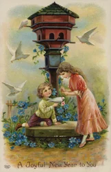 Garçon et fille envoyant des vœux de Noël par colombe