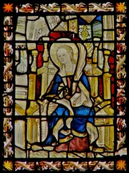 La fenêtre est représentant Sainte Foi portant son emblème, la scie