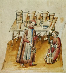 Un pharmacien et son assistant pilent des herbes et des racines à usage médical, vers 1380-1400
