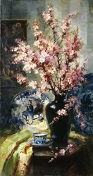 Fleurs de pommier et porcelaine bleue et blanche sur une table