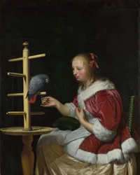Une femme en veste rouge nourrissant un perroquet
