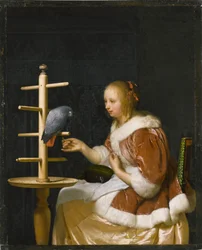 Jeune femme nourrissant un perroquet
