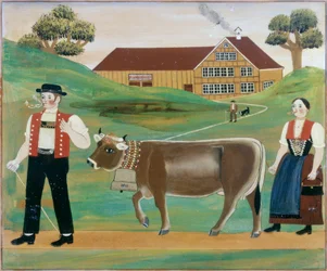Fermier et fermière avec une vache