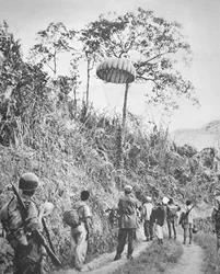 Soldats français et vietnamiens récupérant des fournitures parachutées, pendant le siège de Diên Biên Phu, novembre 1953-mai 1954