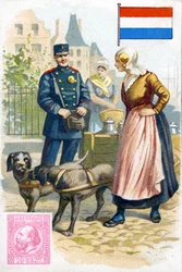 Facteur en Hollande parlant à une femme livrant du lait dans une charrette à chien, fin du XIXe siècle