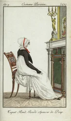 Femme à la mode assise devant une cheminée