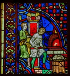 Vitrail représentant des boulangers au Moyen Âge cuisant du pain dans un four