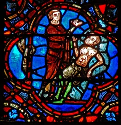 Fenêtre w12 représentant une scène dans la fenêtre du Bon Samaritain : un autre voyageur voit le pèlerin blessé