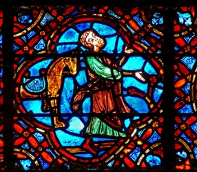 Fenêtre w12 représentant une scène dans la fenêtre du Bon Samaritain : le Samaritain descend de son cheval