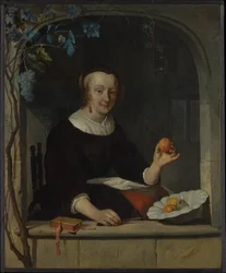 Une femme assise à une fenêtre