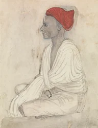 Homme en turban rouge assis en tailleur