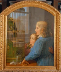 Deux enfants devant une cage à perroquet