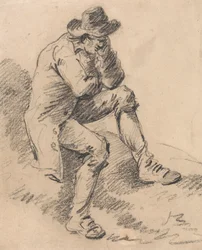 Homme assis sur une berge