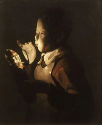 Garçon soufflant sur une lampe