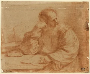 Homme barbu assis à table