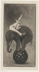 Éléphant en équilibre sur une balle avec un homme sur son dos