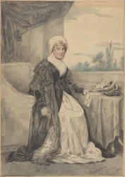Femme assise à une table, tenant une lettre