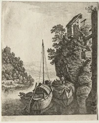 Deux bateaux amarrés sous un rocher