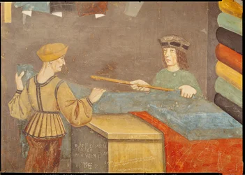 Un marchand de tissus mesurant du tissu