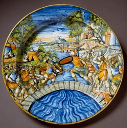 Épisode de la défense du pont Sublicius par le légendaire héros romain Horatius Coclès pendant les combats contre les Étrusques. Assiette en céramique produite à Urbino dans l