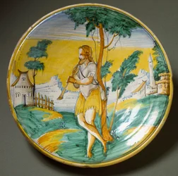 Joueur de flûte dans un paysage. Plat en céramique produit à Viterbe, Italie. Fin du XVIe siècle, Florence, Museo Nazionale del Bargello