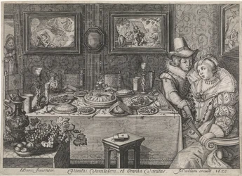 Jeune couple assis à une table richement garnie