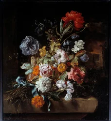 Bouquet de fleurs déposé sur un banc de pierre