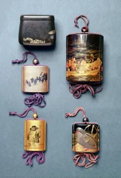 Inro et pochette à tabac : de gauche à droite : Pochette à tabac avec design Hiramaki-e, signée Zeshin ; Inro, procession de mariage de renards en Sumi-e Togidashi, signée Toyo ; Inro, deux sages lisant un rouleau en Sumi-e