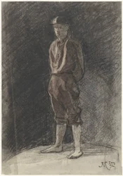 Homme debout avec un casque et des bottes roulées