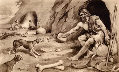 Homme des cavernes nourrissant un chien