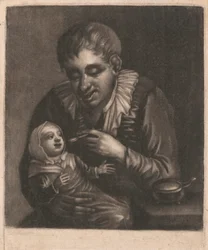 Homme nourrissant un enfant