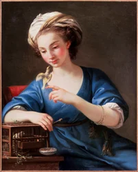 Jeune femme en costume turc jouant avec un oiseau sorti de sa cage. Elle est coiffee d