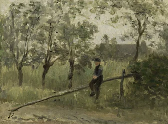 Garçon de campagne sur une barrière