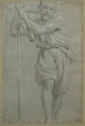 Un homme appuyé sur une croix en bois