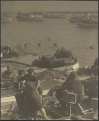[Des hommes assis dans des bateaux]