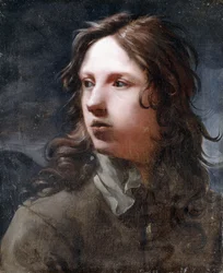 Un jeune homme, buste, en veste grise