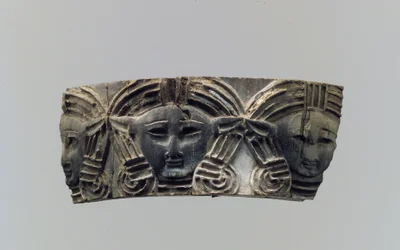 Plaque de meuble ou de boîte à cosmétiques en cloisonné avec trois têtes frontales, c.8e-7e siècle av. J.-C.